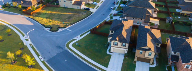 A group of suburban houses. Each house has a slight difference, but for the most part, they are identical with each other.