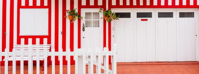 A colorful red and white striped house facade.