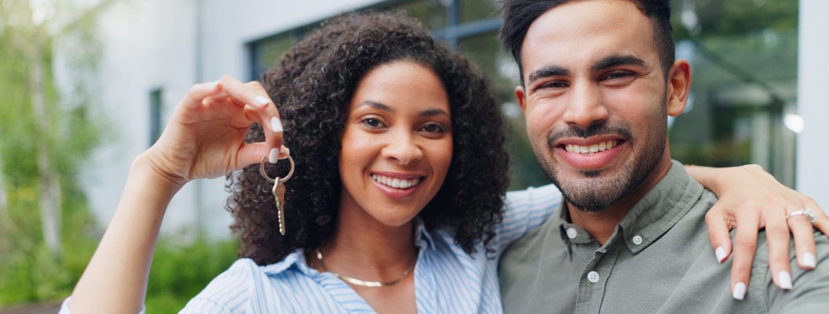 Couple, hug and new home with keys, portrait
 and smile together from property investment outdoor. .