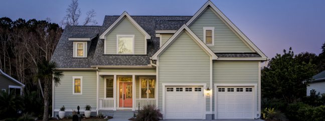 Front elevation of beautiful home lit up at twilight.