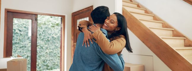 Hug, couple and excited in new home for real estate, investment and freedom or financial security. .