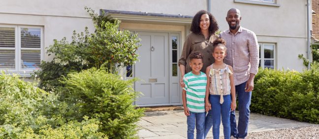 Portrait Of Smiling Family Standing Outside Home Together, home loan article